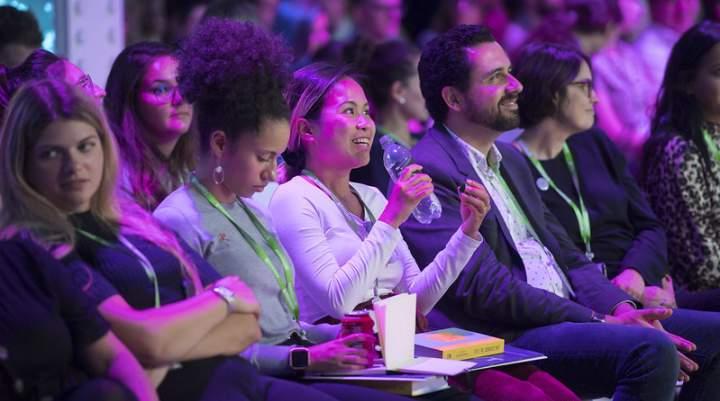 A woman asking a question at an event